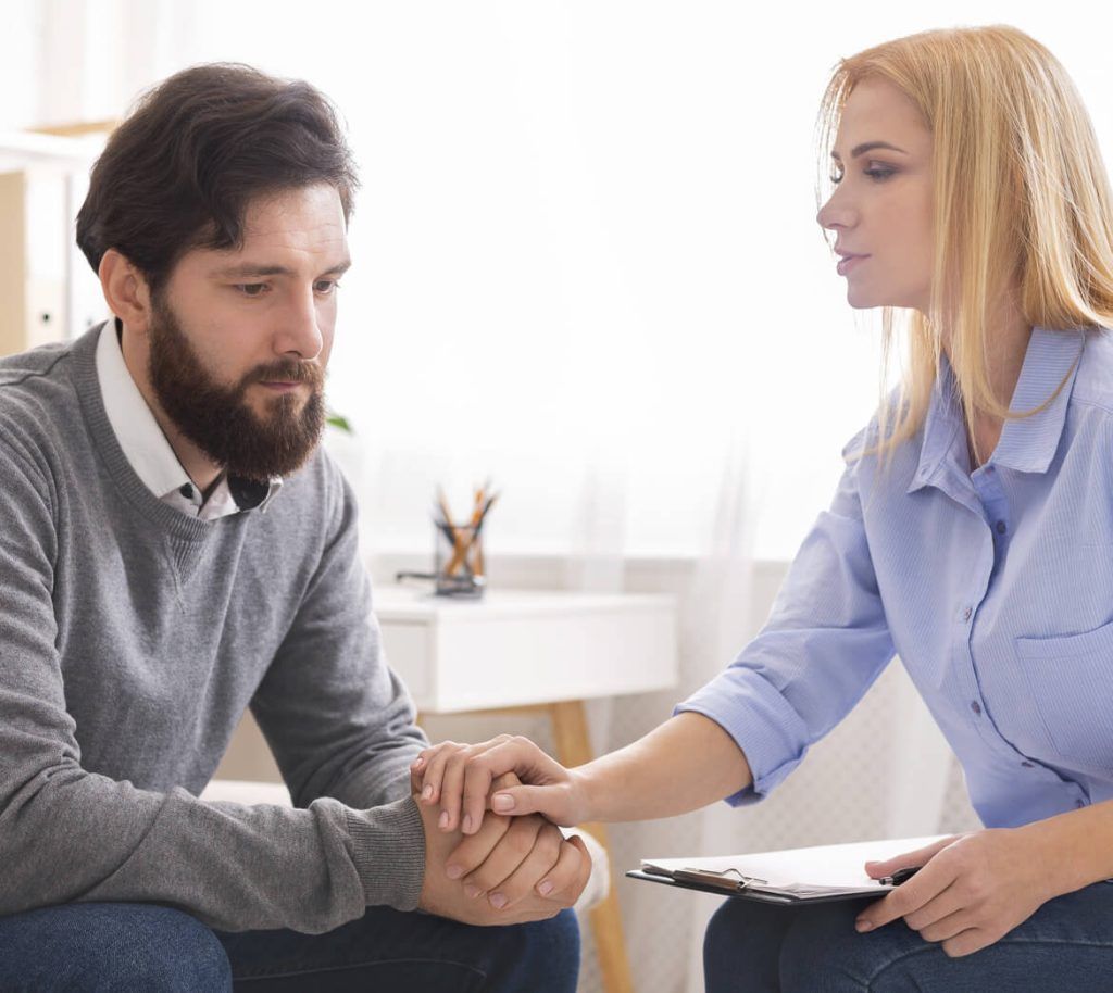 psychologist comforting depressed man patient at c CRMC45F